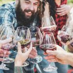 group of people clincking glasses together
